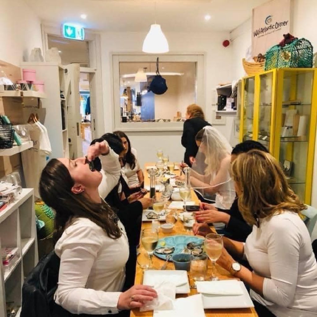 A hen party tasting oysters on the food tour
