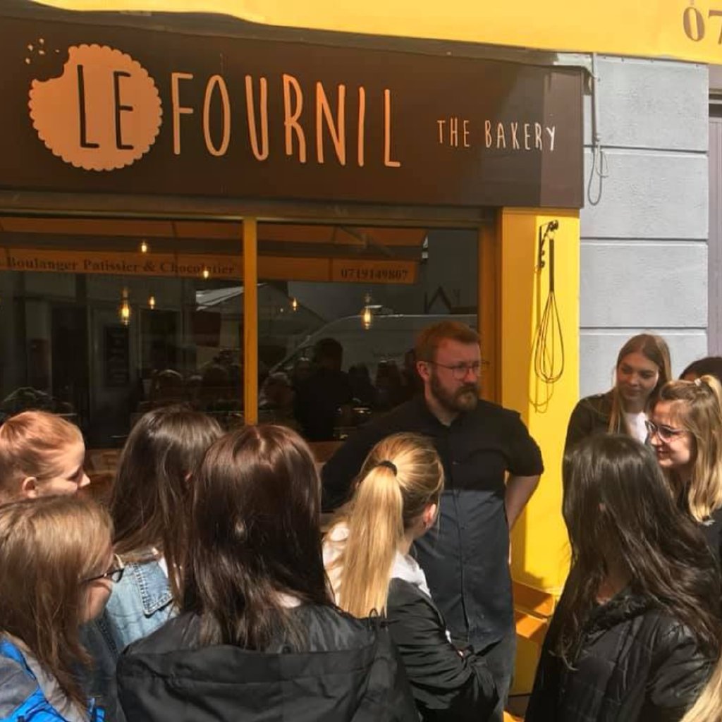 A group outside Le Fournil getting insider information