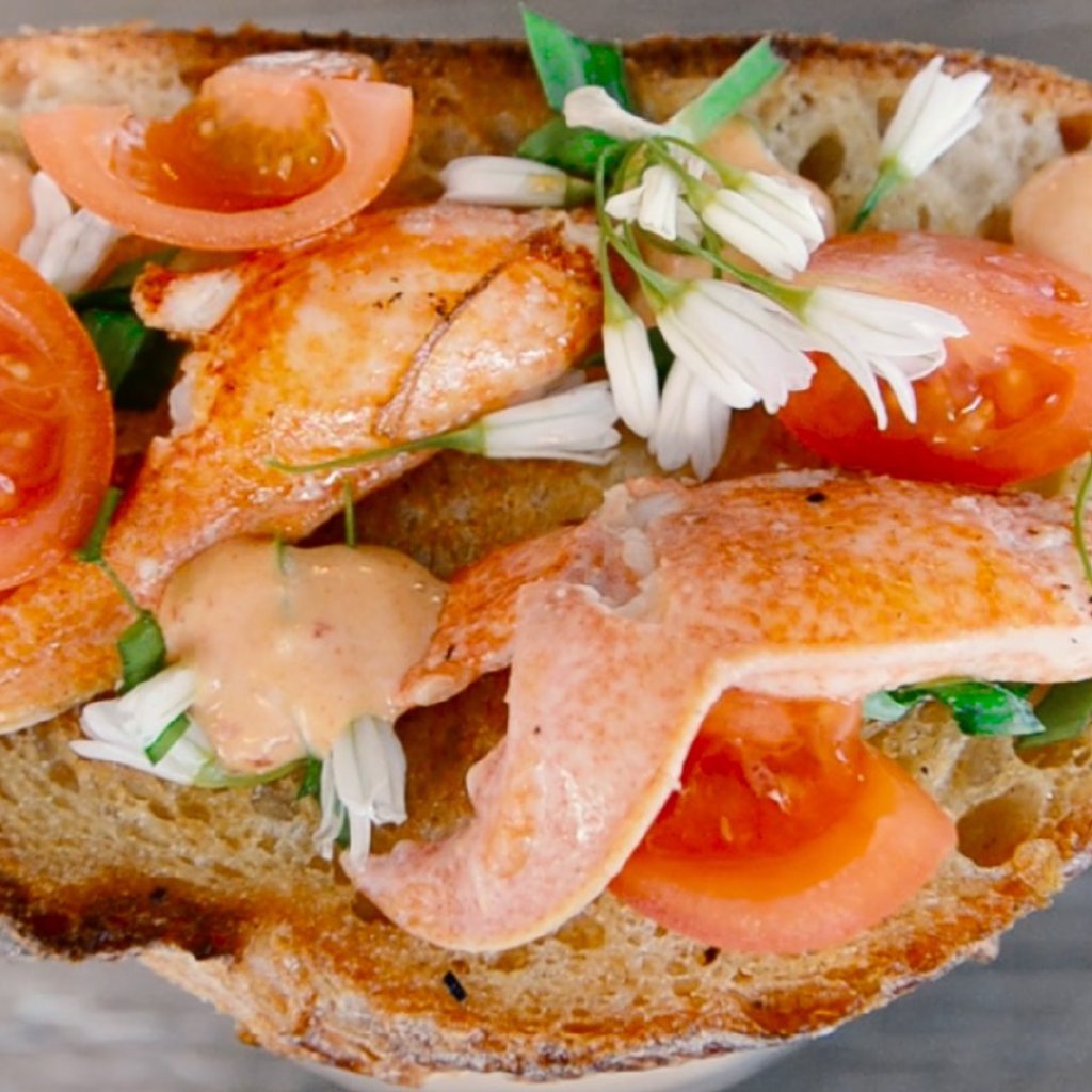 Smoke Salmon slivers on a slice of sourdough bread