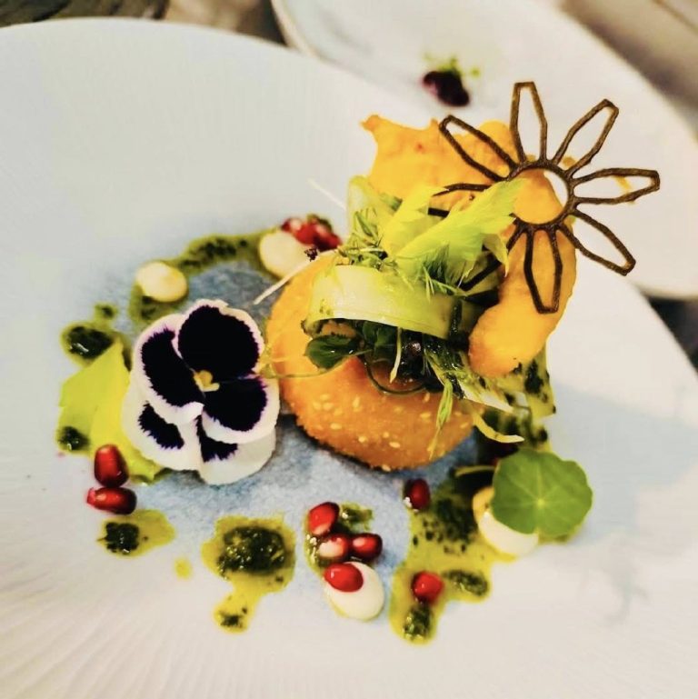 A plate of beautifully decorated food at Eala Bhan