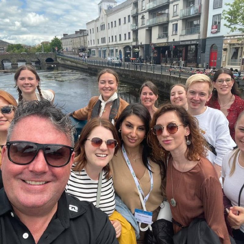 Anthony Gray posing with a group enjoying the food tour